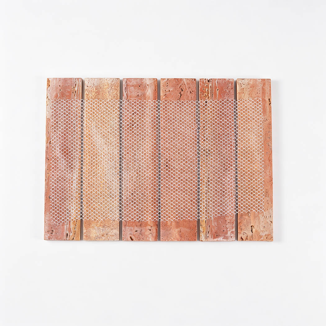 Back view of a red travertine strip mosaic tile with flexible mesh backing