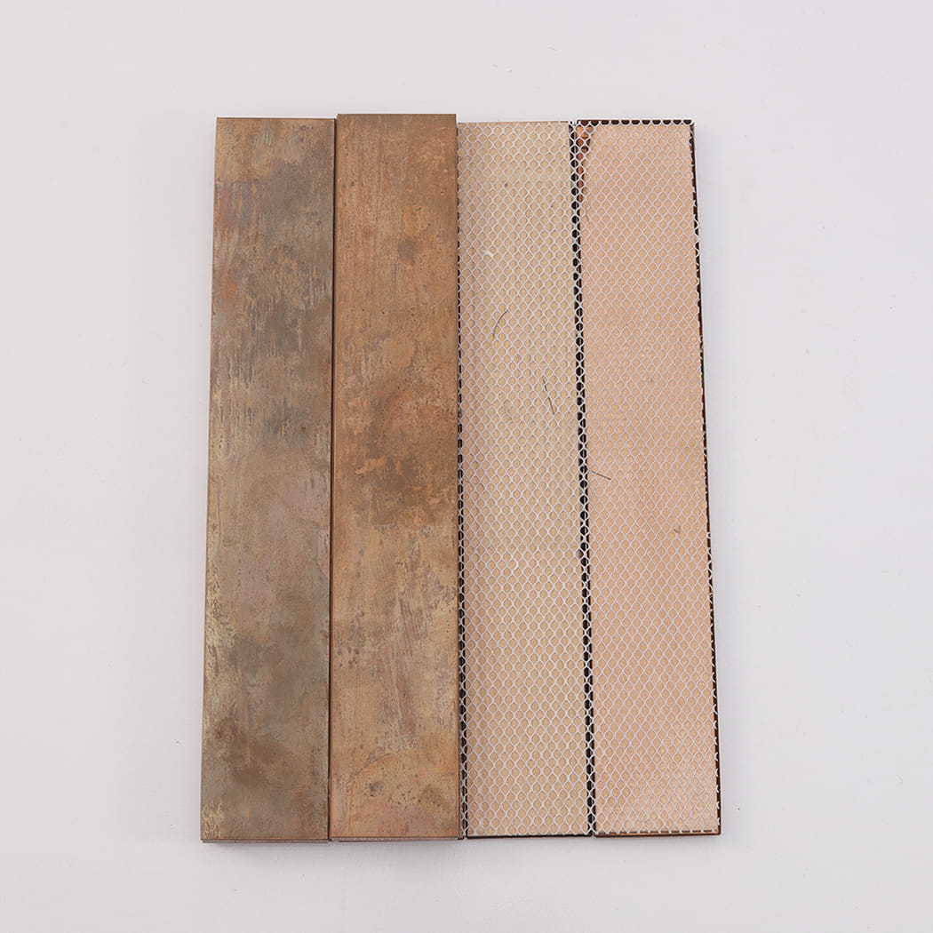 Rear view of tile strips showing the white mesh backing used for easy wall installation.