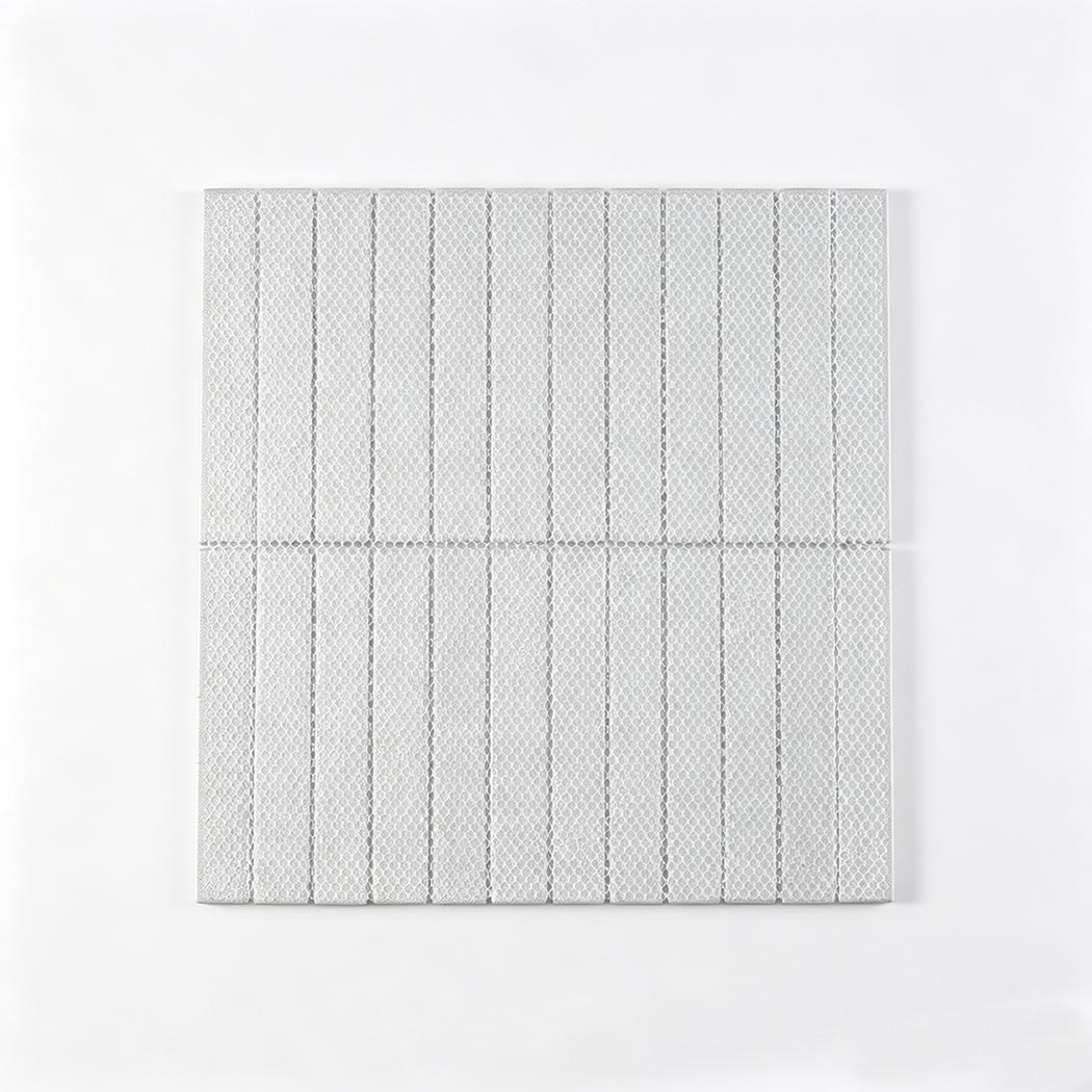 Rear view of the linear mosaic tile sheet showing the white netting mesh backing.