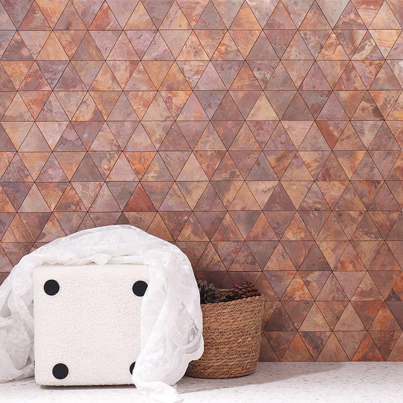 Copper metal backsplash tiles in geometric triangle pattern wall design