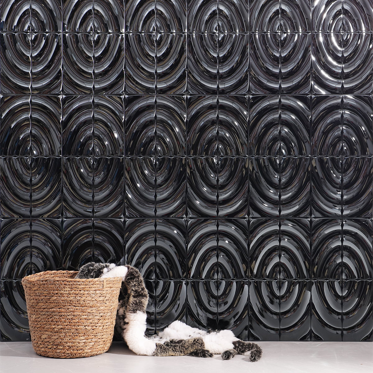 Wall featuring metallic wavy tiles with a basket and fabric draped in front 