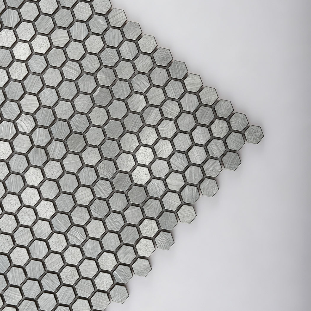 Close up of sleek metallic brushwork on mini silver hexagon sheet
