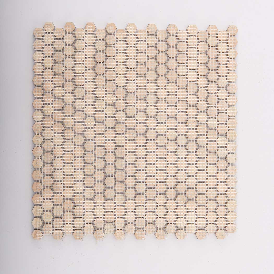 Reverse side of mini gold hexagon aluminum wall tile showing mounting net