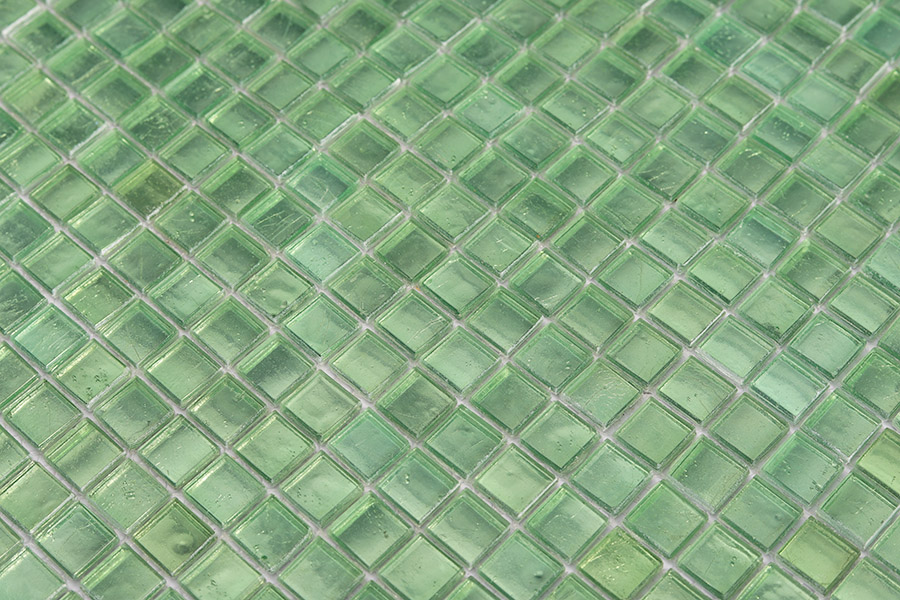 Close-up of mint green vitreous glass tiles showing natural texture and non-porous finish.