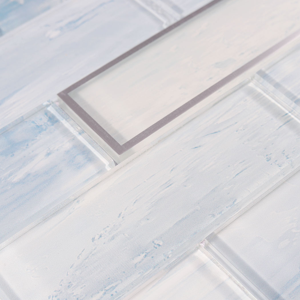 Glossy mist blue glass subway tiles with soft brush texture and silver border