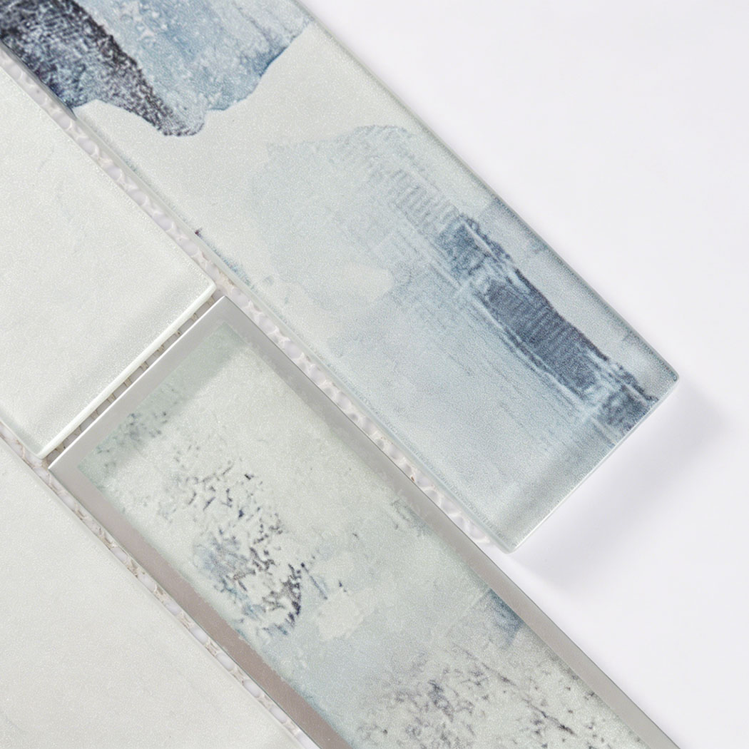 Close detail of blue wash glass subway tile with silver frame and glossy surface