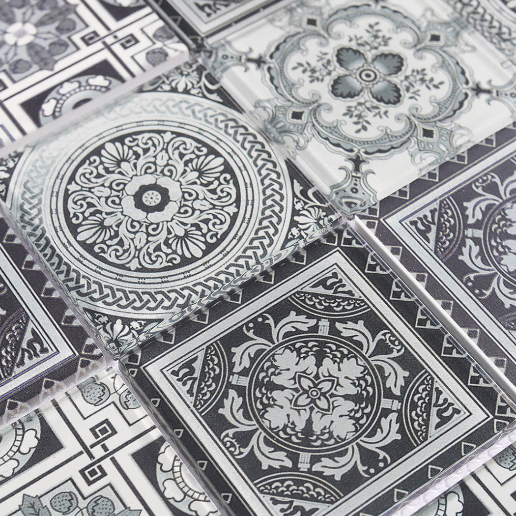 Mixed floral and geometric black white glass tile pattern close up