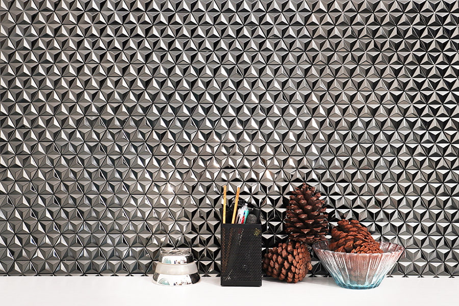 Modern 3D metal wall texture with desk decor, pinecones, and glass bowl