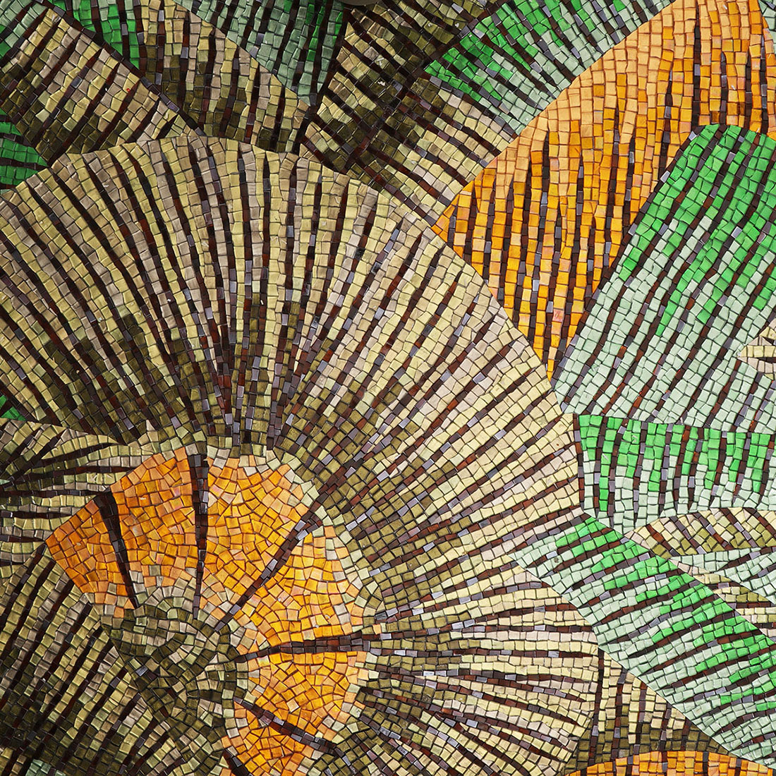 Close-up of detailed leaf shapes in green and brown mosaic tiles