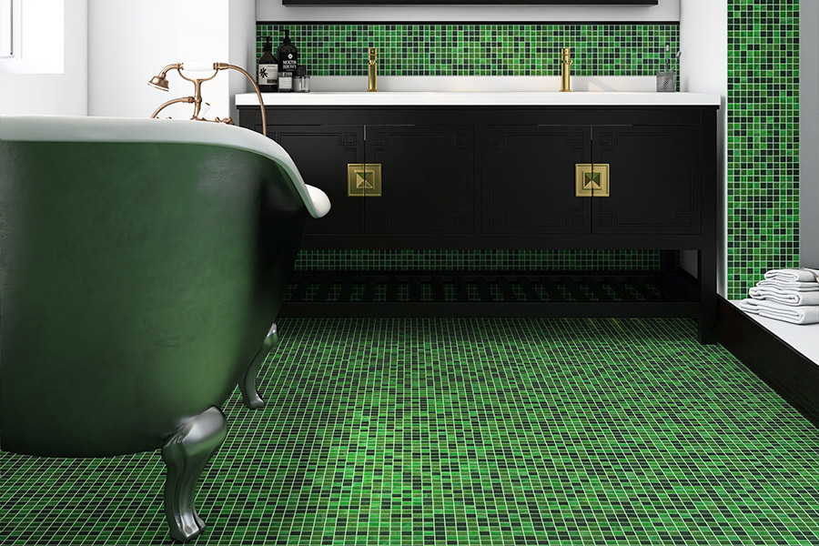 Moss green vitreous glass mosaic floor tiles in a luxury vintage bathroom with a green clawfoot tub.