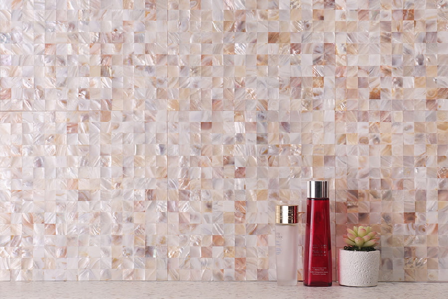 Close-up of Mother of Pearl square tiles with decorative items