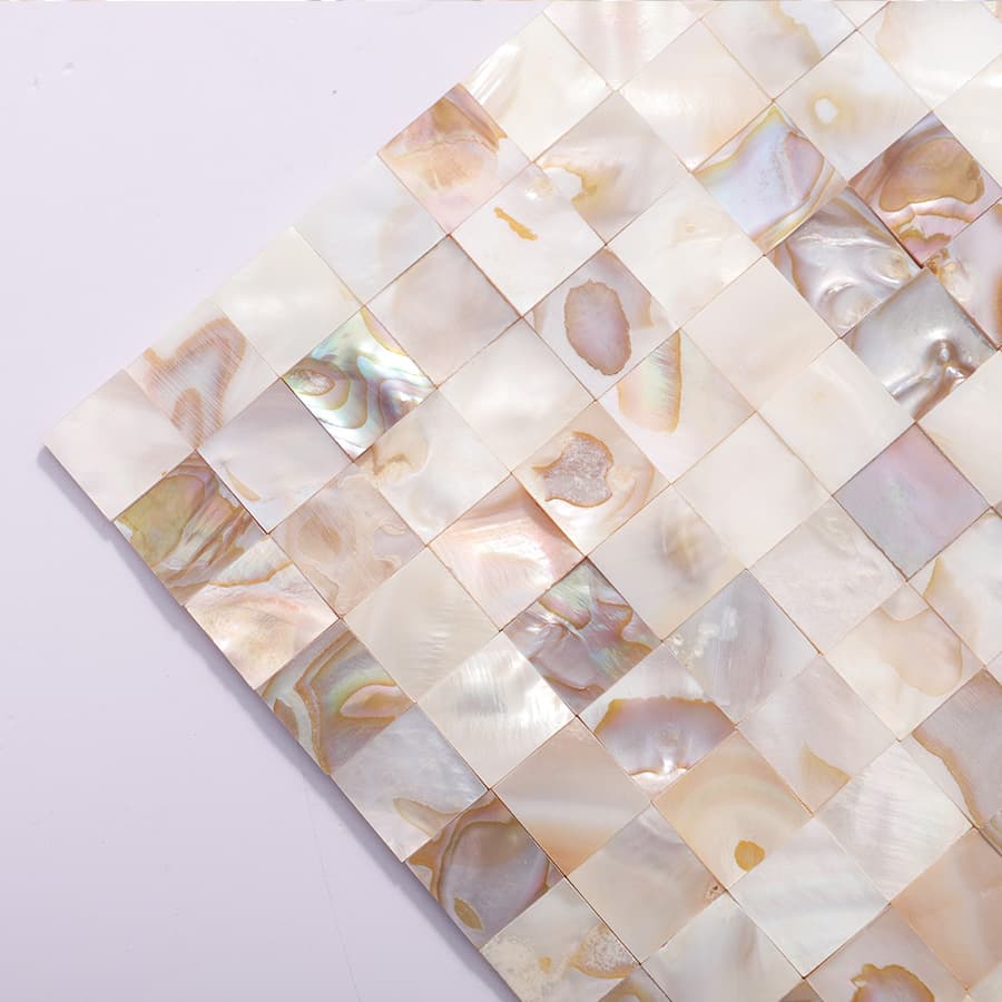 Angled view of multicolor shell mosaic tile sheet with vivid textures