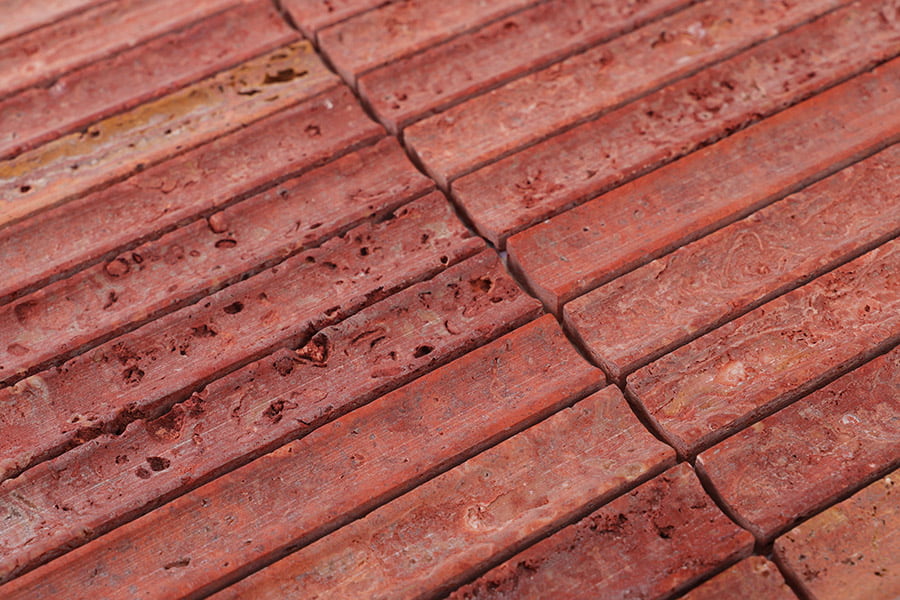 Natural red travertine stone bricks with detailed surface texture