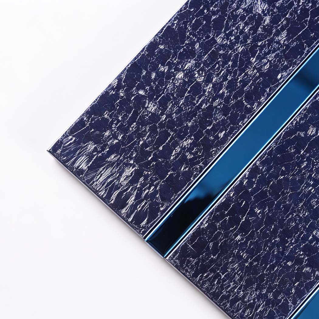 Close-up of navy blue glitter linear mosaic tiles with glossy blue metal trim