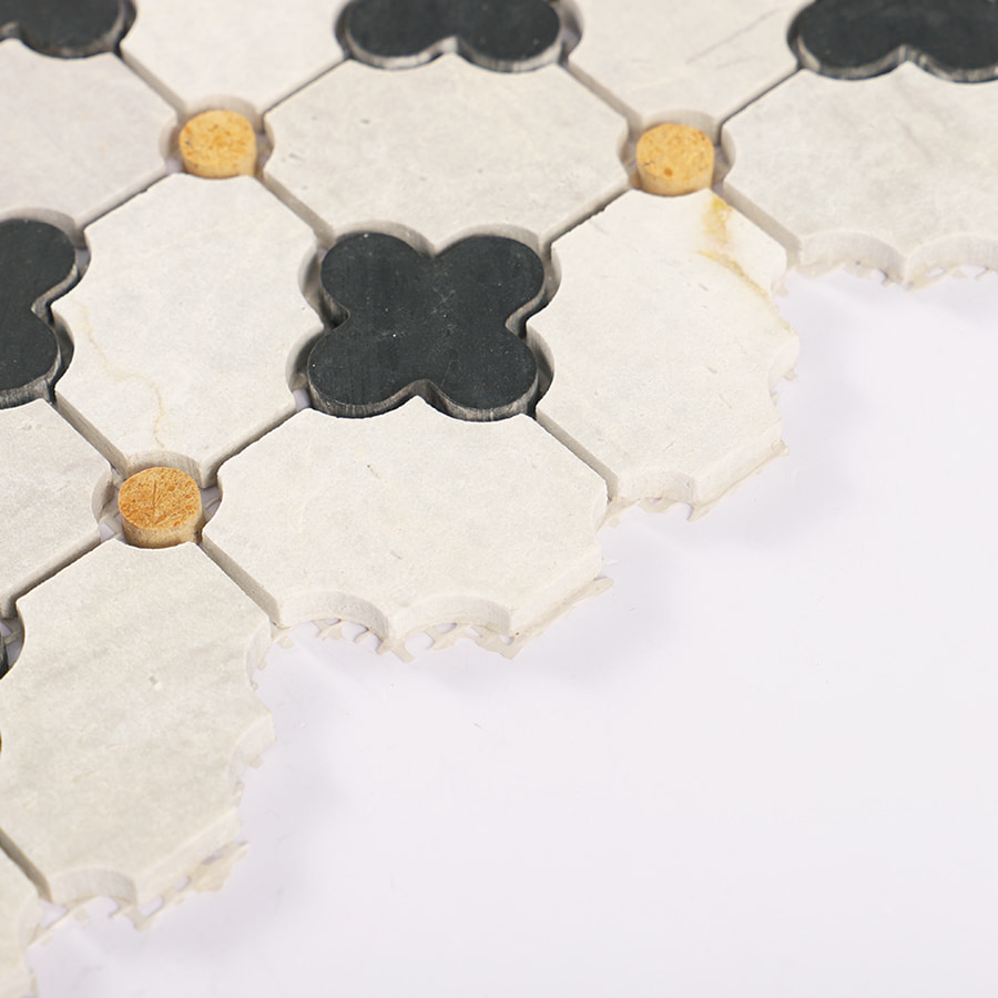 Edge view showing texture and thickness of Nero Marquina gray clover marble mosaic tile