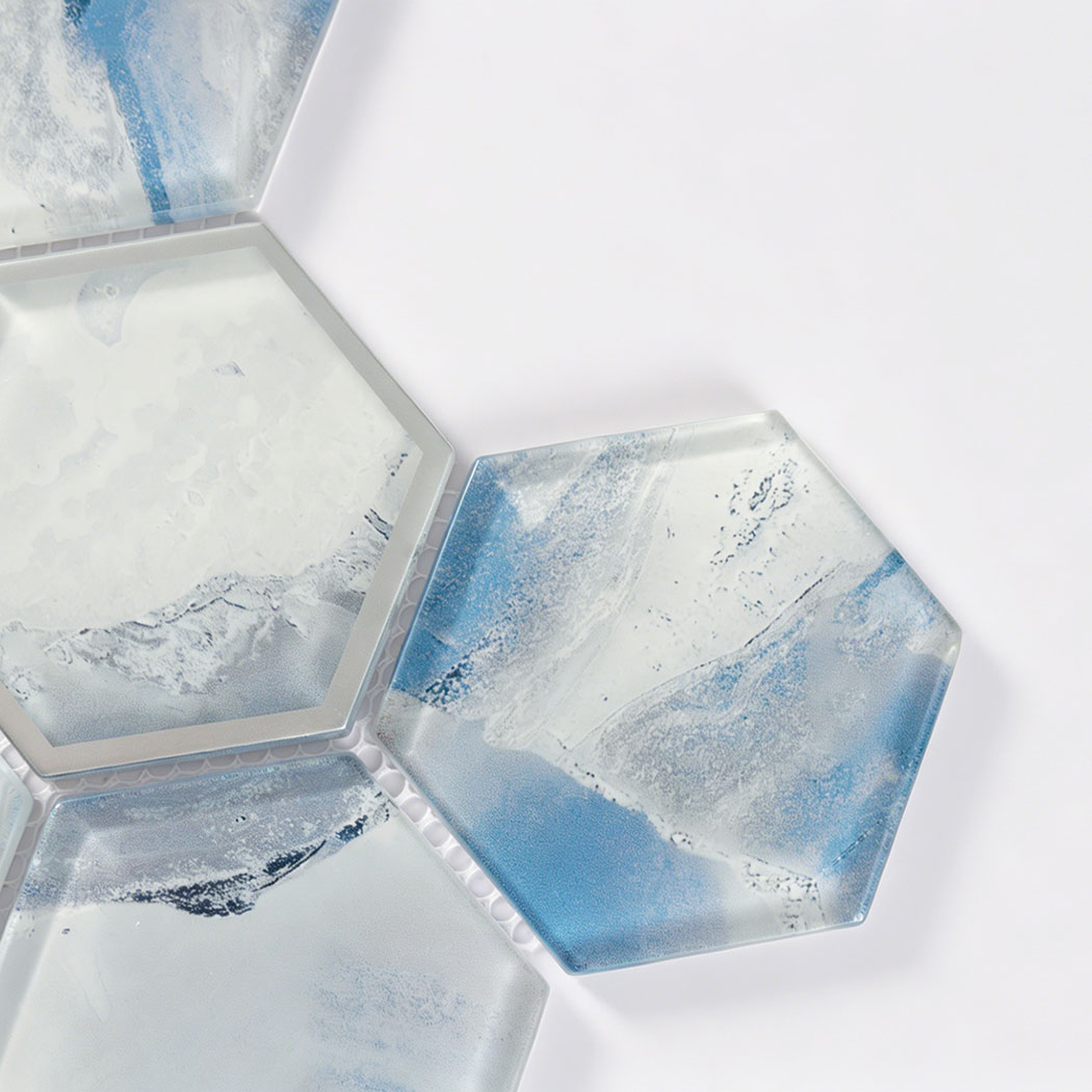 Ocean blue hexagon glass tile detail with white swirls and silver framed accent