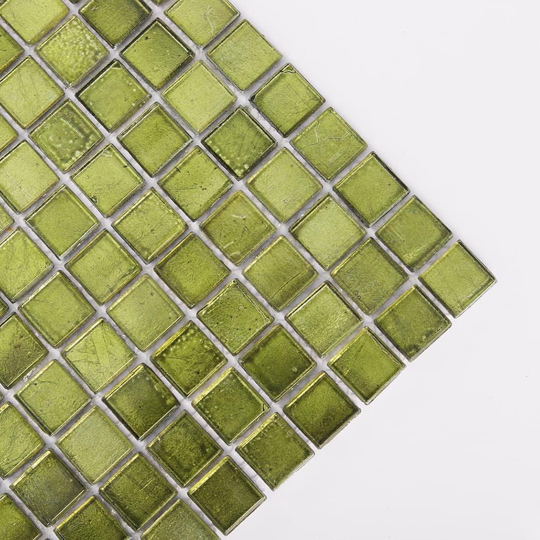 close up of olive green glass mosaic tile corner showing foil texture