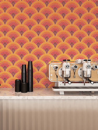 Orange fan-shaped glass mosaic backsplash in a stylish coffee shop