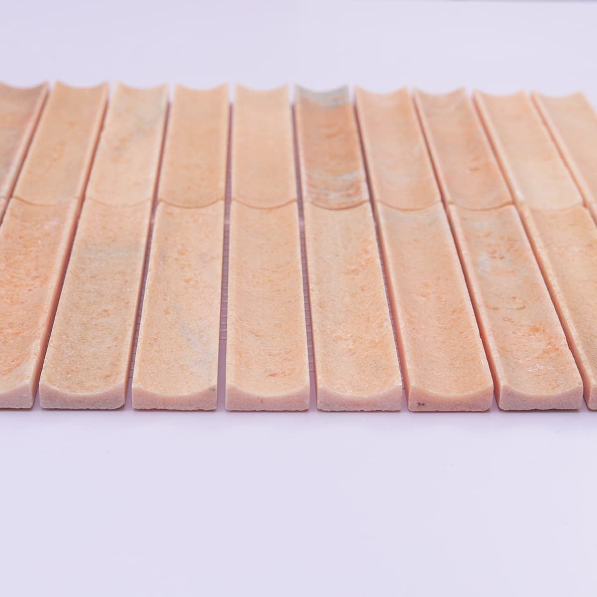 Front low-angle view of orange fluted travertine strips