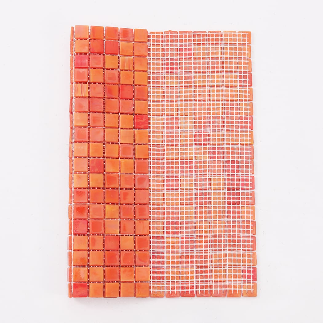 Orange mixed square glass mosaic tile sheet with visible white mesh backing