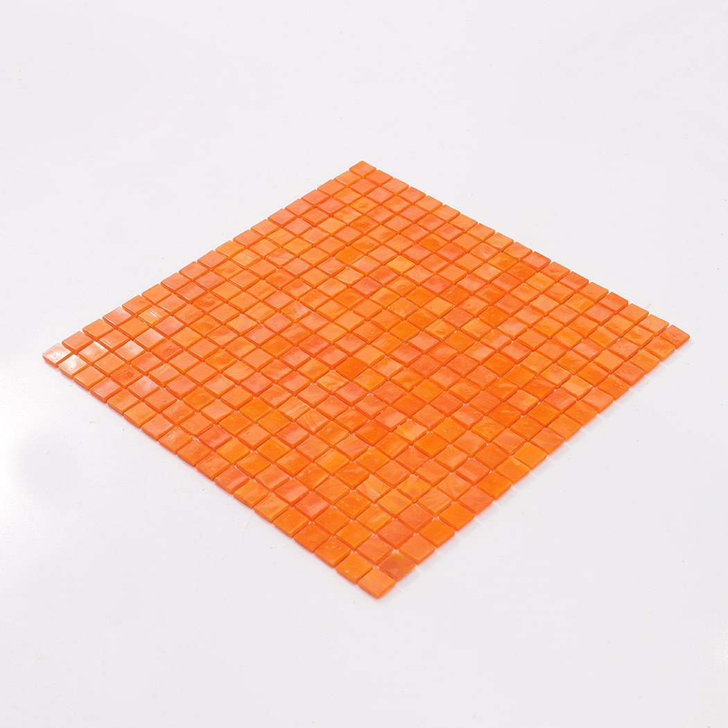 Angled view of a full orange peach square glass mosaic tile sheet