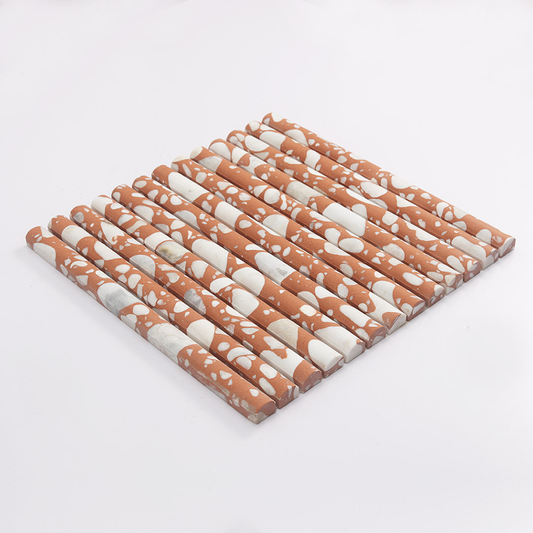 Side view of orange terrazzo rounded fluted mosaic tile on a white background