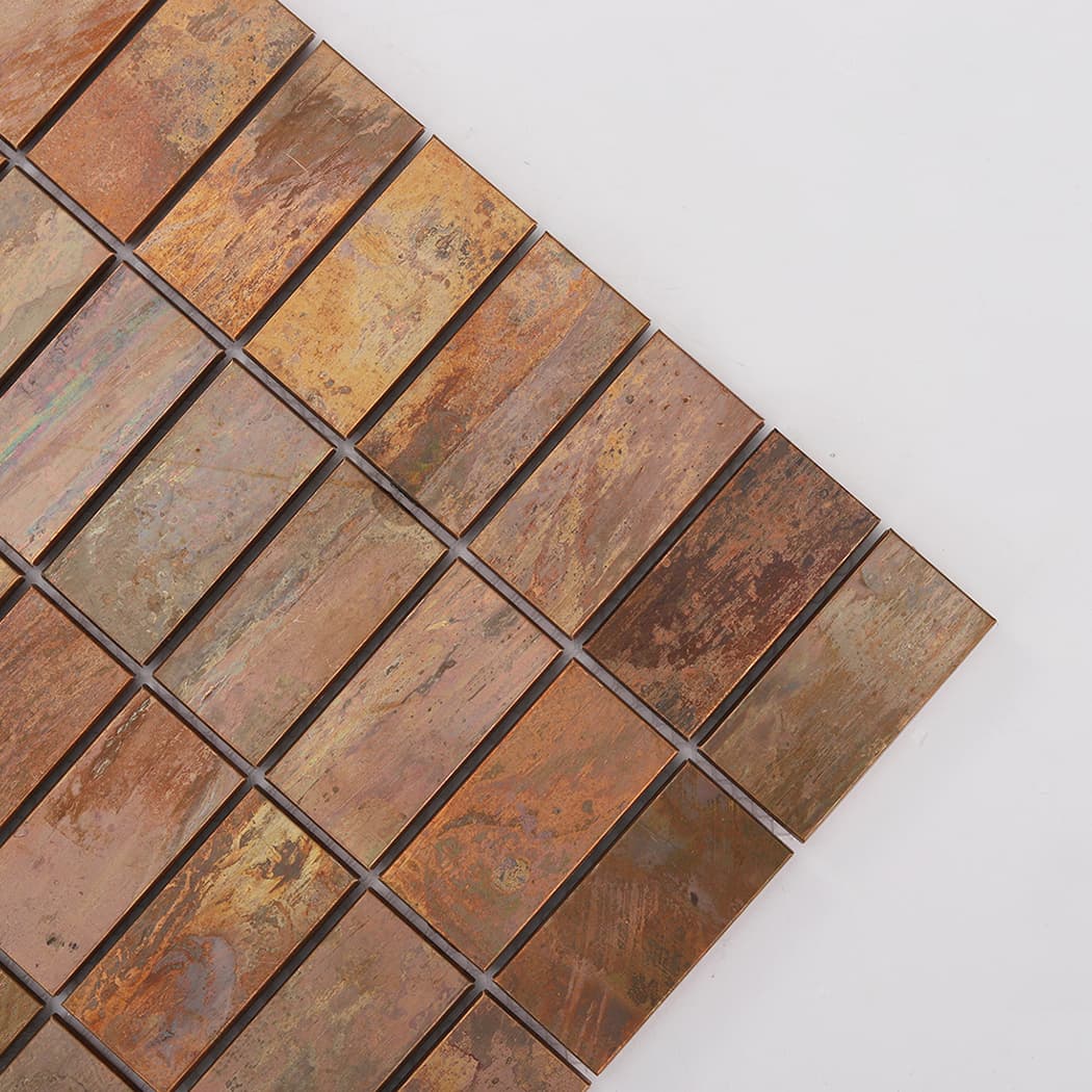 Corner close-up of oxidized copper rectangular mosaic tiles with varied patina