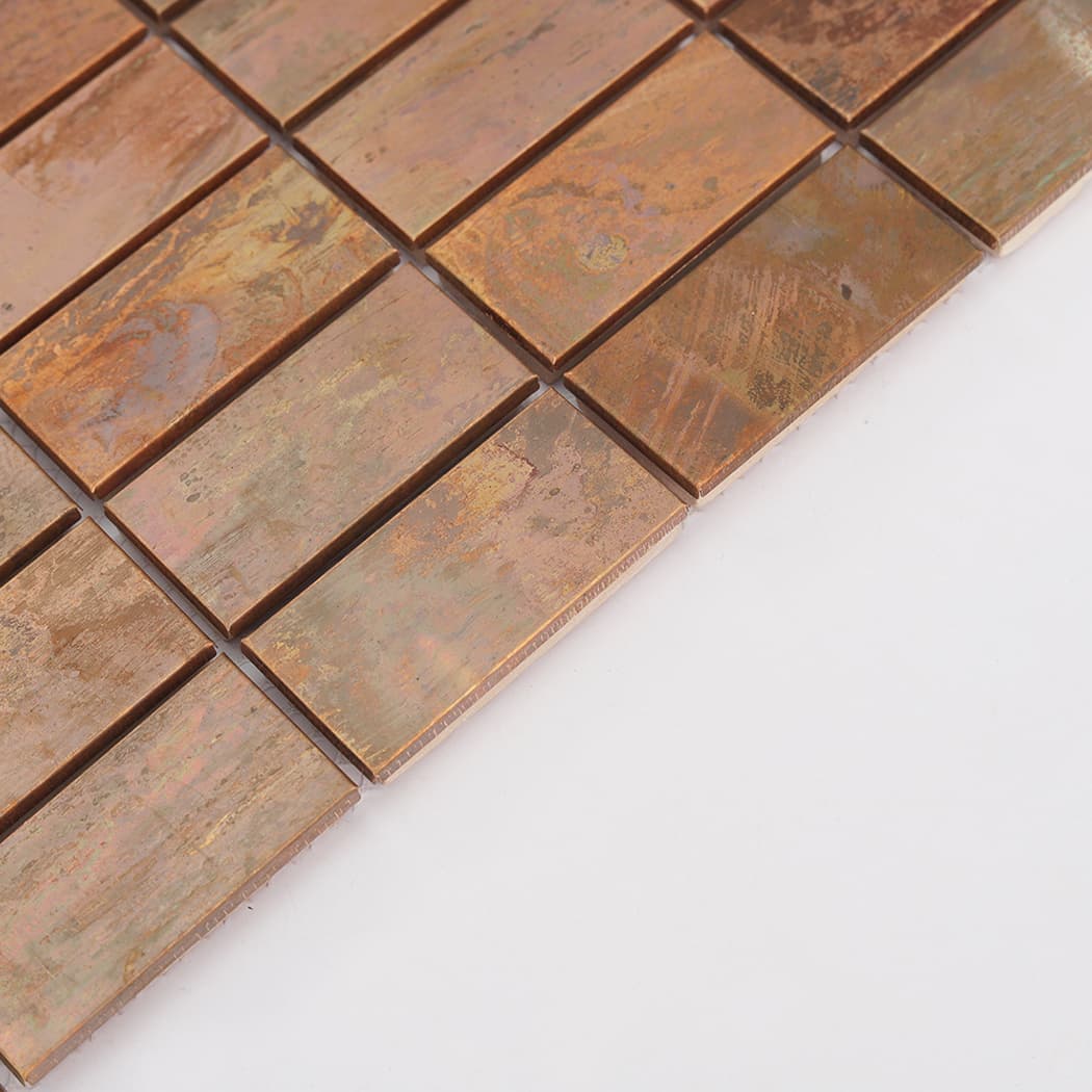 Edge detail of oxidized copper rectangular mosaic tiles with raised surface