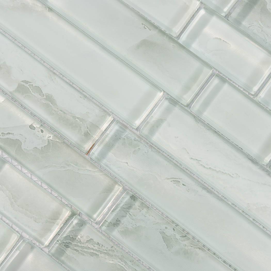 Pale aqua glass linear tile surface with cloudy veining and translucent glossy finish