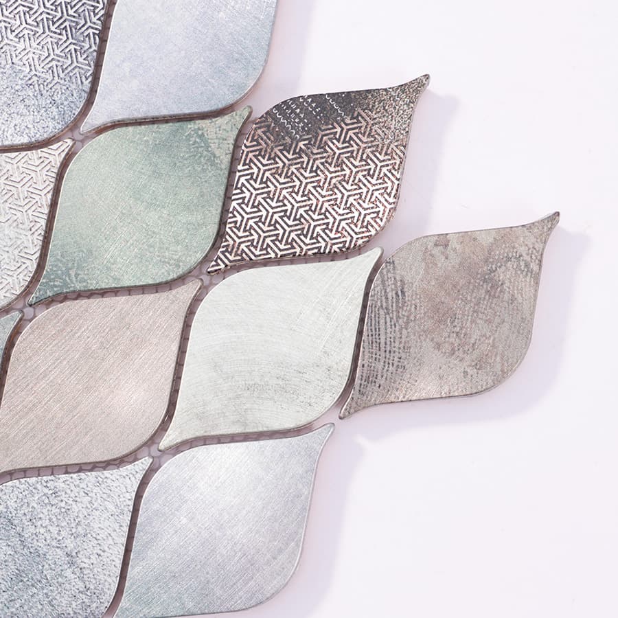 Close-up corner of patterned leaf aluminum mosaic metal tile