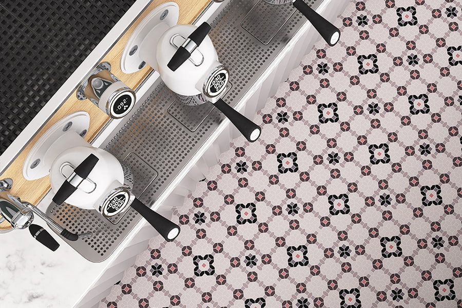 Patterned cafe floor tiles viewed from above near espresso machine