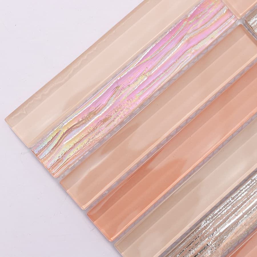 Glossy finish of peach pink and silver glass mosaic tile surface