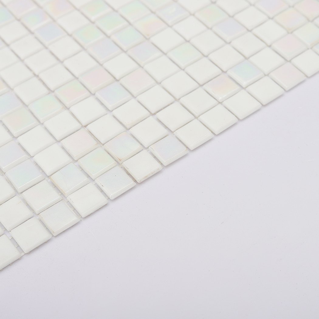 angled edge view of pearl white glass mosaic tile sheet showing raised squares