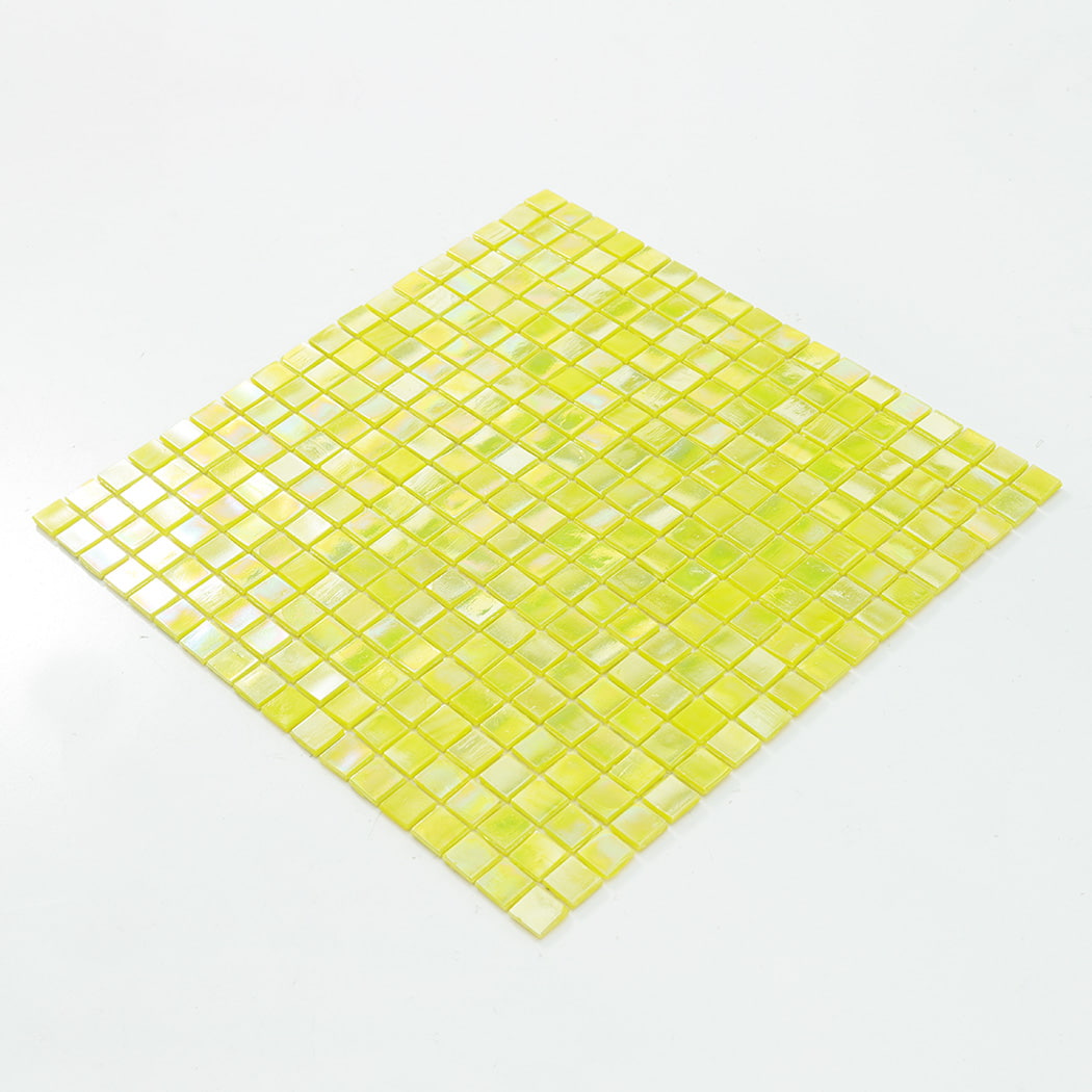 Angled view of a square iridescent yellow mosaic tile sheet on a plain white surface.