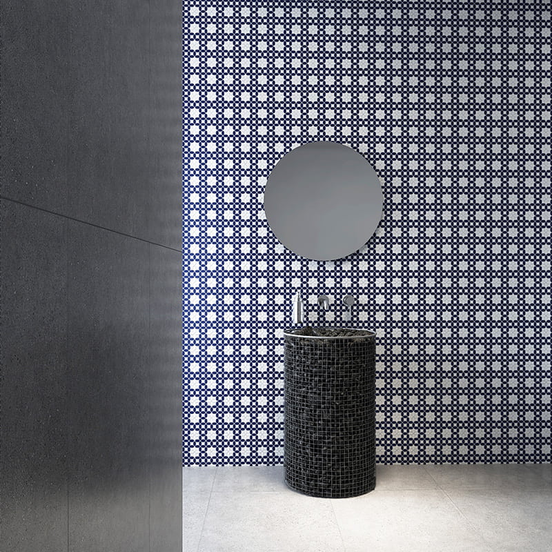 Picket tile bathroom with geometric blue and white wall and round sink

