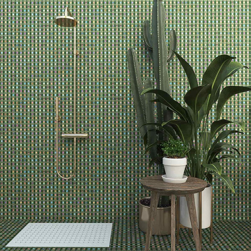 Picket tile shower wall with green mosaic pattern and gold shower fixture

