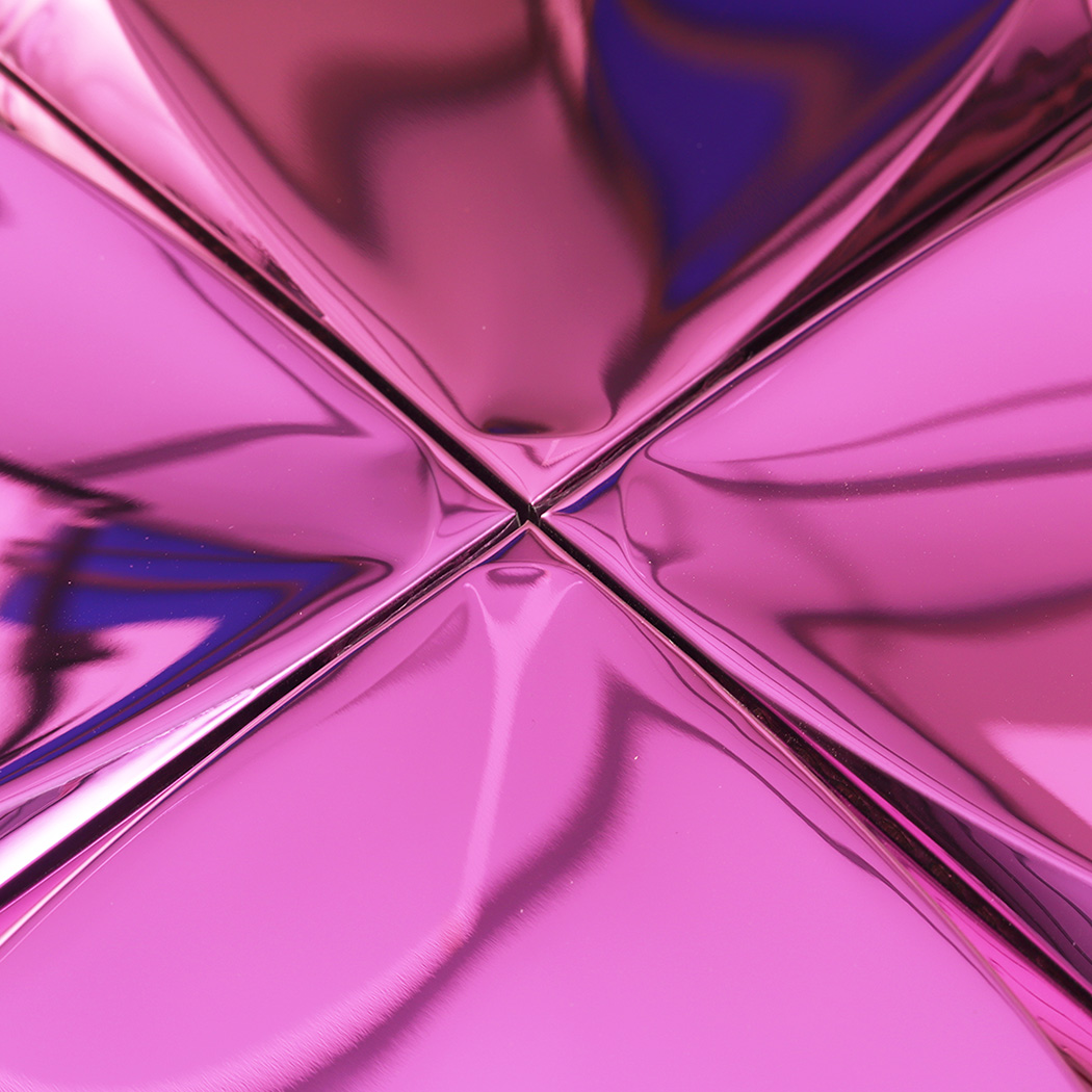 Close up view of the center point where four pink 3D metal tiles join together.