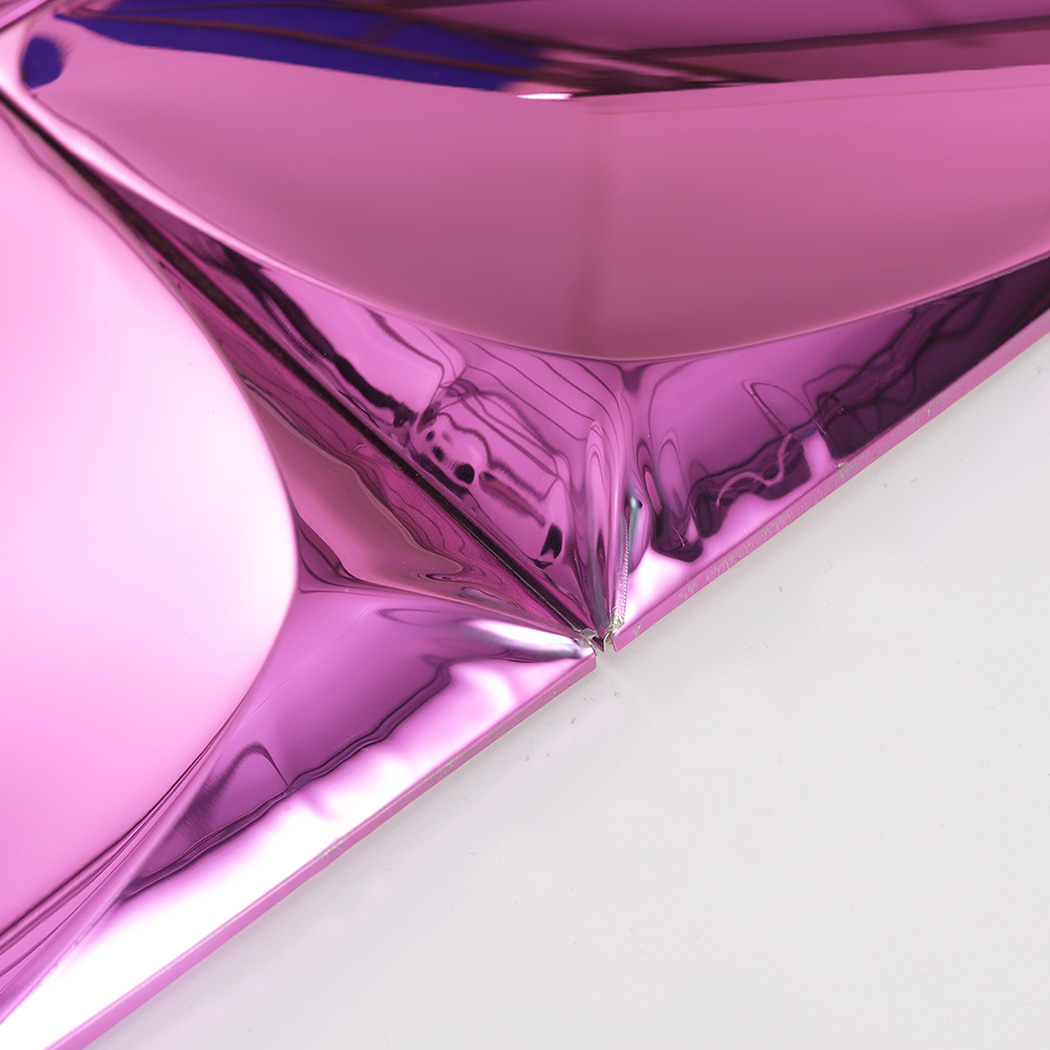 High angle detail of a pink 3D wall tile corner showing the raised geometric texture.