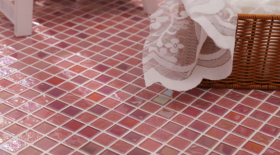 Pink glass mosaic floor with delicate lace overlay and wicker basket detail 