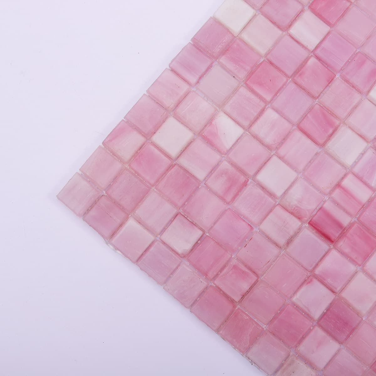  Close-up of the corner section of pink glass mosaic tiles showing smooth edges and texture