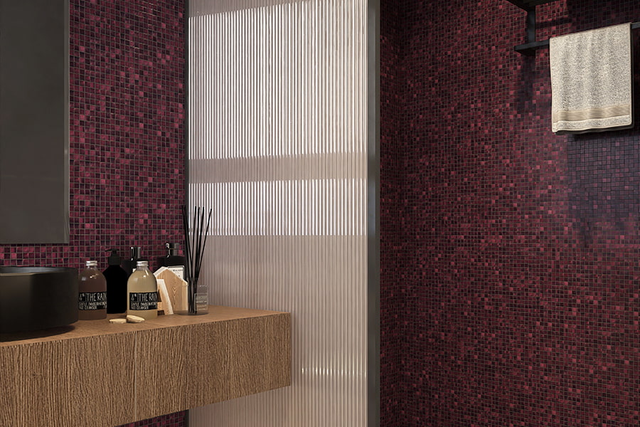 Shower area featuring rich purple mosaic tiles and a floating wood vanity