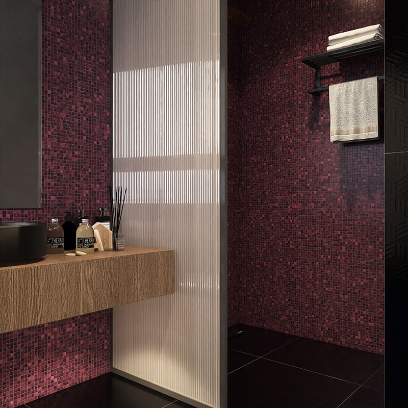 Close-up of deep purple glass mosaic tiles on a shower wall