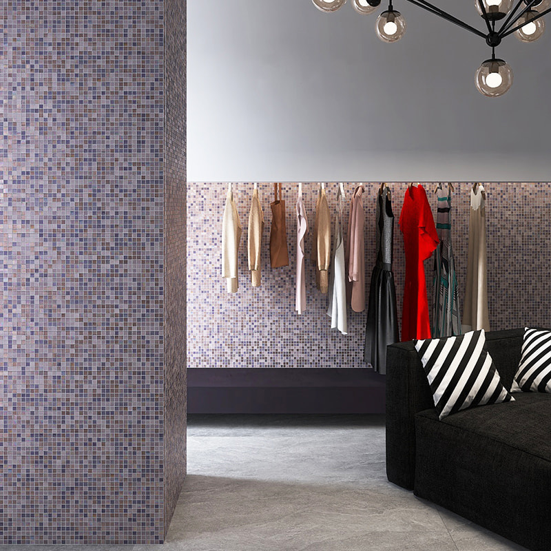 Dresses hanging on a rack before lavender-purple mosaic tile wall 
