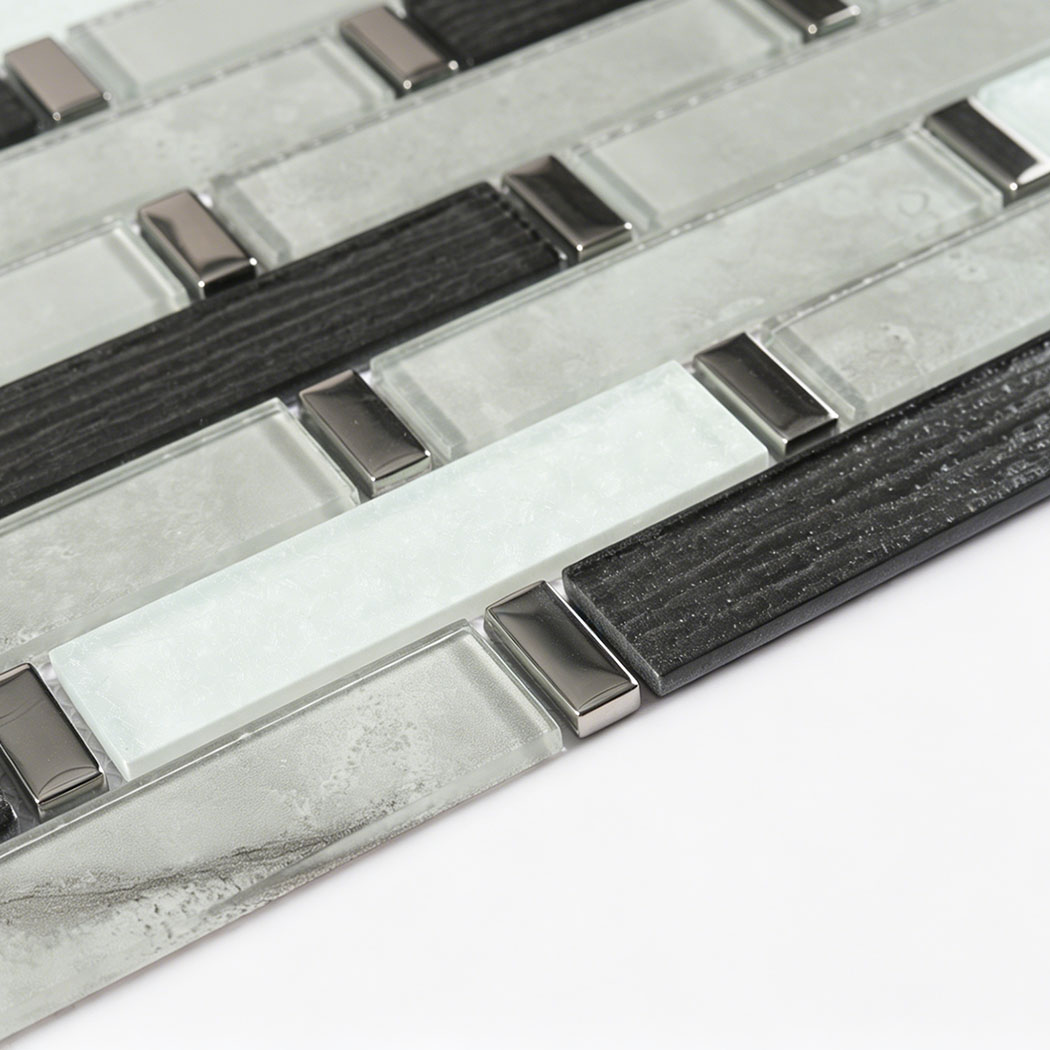 Low angle view of raised black white and silver glass linear mosaic chips