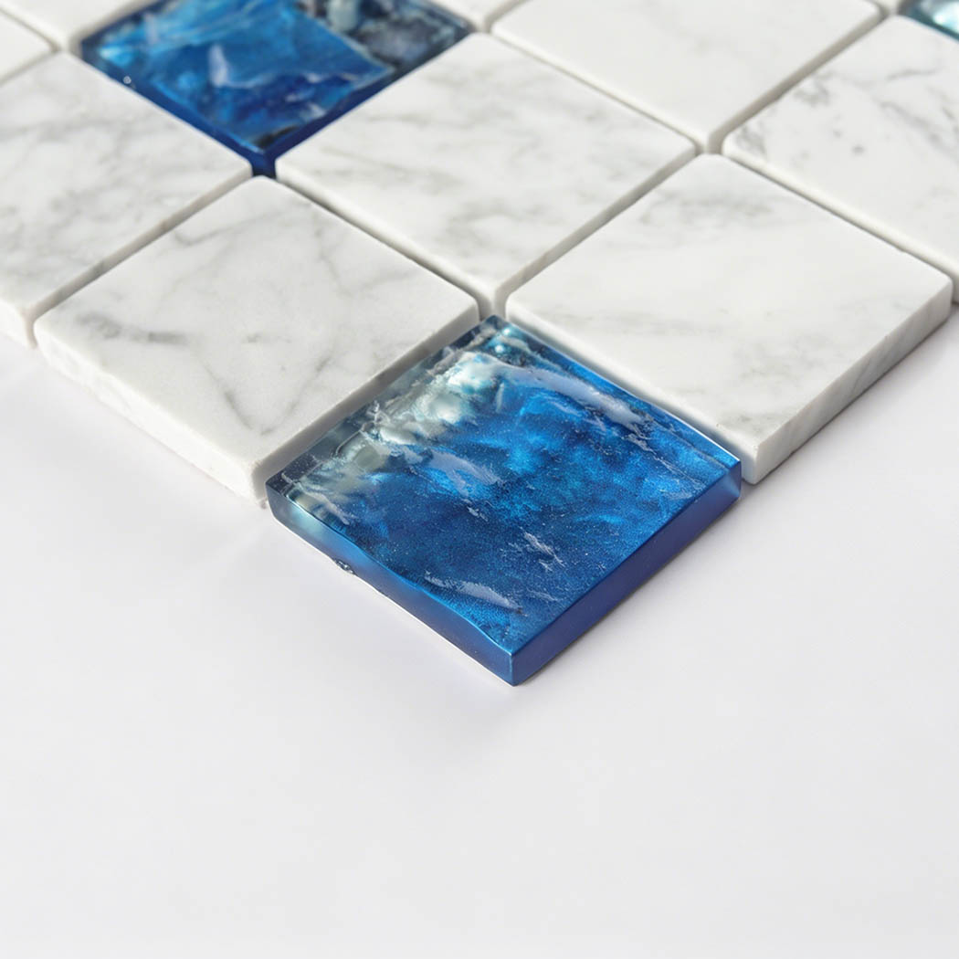 Raised blue glass square insert with white marble mosaic tiles around it