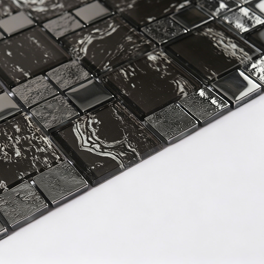 Low angle view of raised black silver glass mosaic tiles with textured gray squares