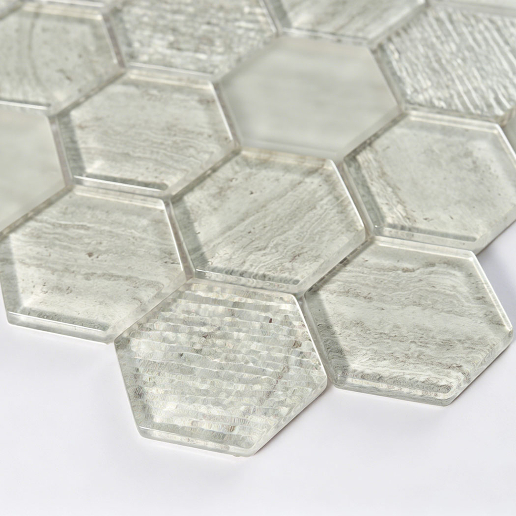 Angled detail of light gray hexagon glass tiles with raised texture and clear edges