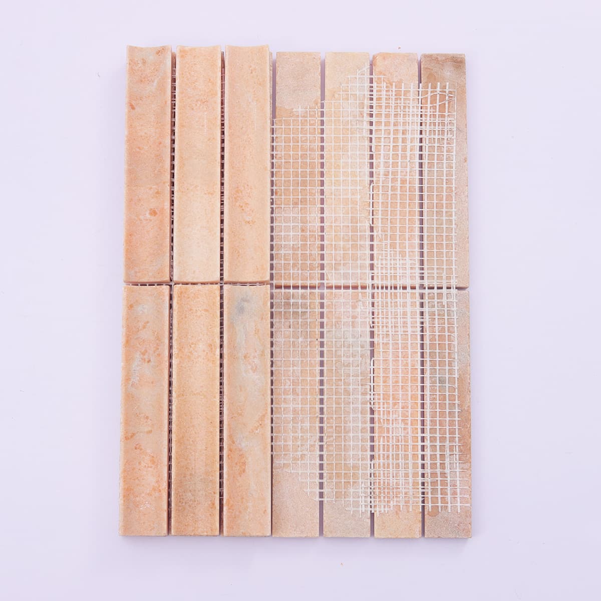 Mesh backing of orange fluted marble mosaic tile