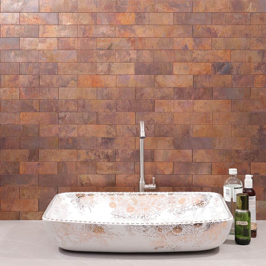 Full wall installation of copper tiles behind ceramic basin
