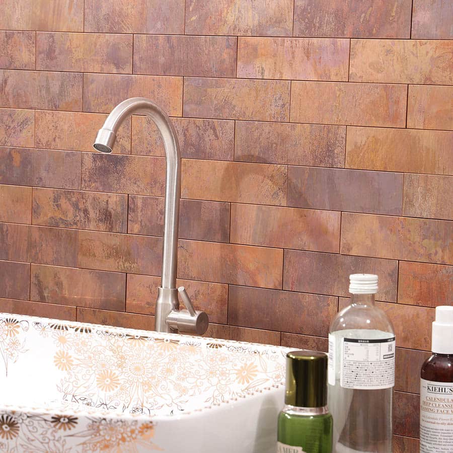Side view of rustic copper tile wall in bathroom setting